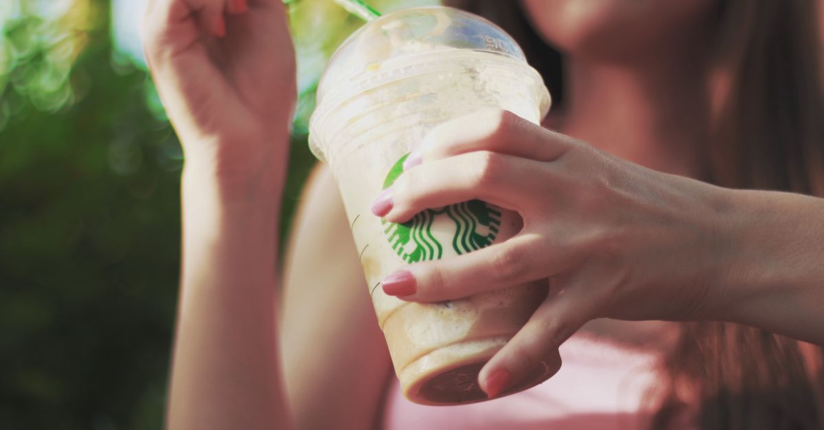 Woman Holding Starbucks Coffee Cup Free Stock Photo woman-holding-starbucks-coffee-cup-free-stock-photo