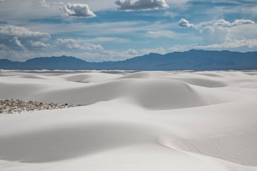 Beautiful landscape of White Sands National Monument with pristine dunes and cloudy sky.