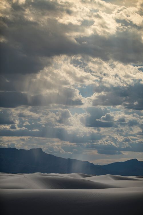 Free Striking landscape with white sand dunes and dramatic sky under cloud cover in the desert. Stock Photo