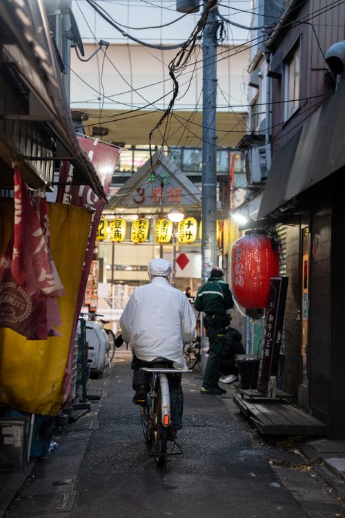 Free A vibrant alleyway in Setagaya City, Tokyo, illuminated with lanterns and bustling with activity at night. Stock Photo