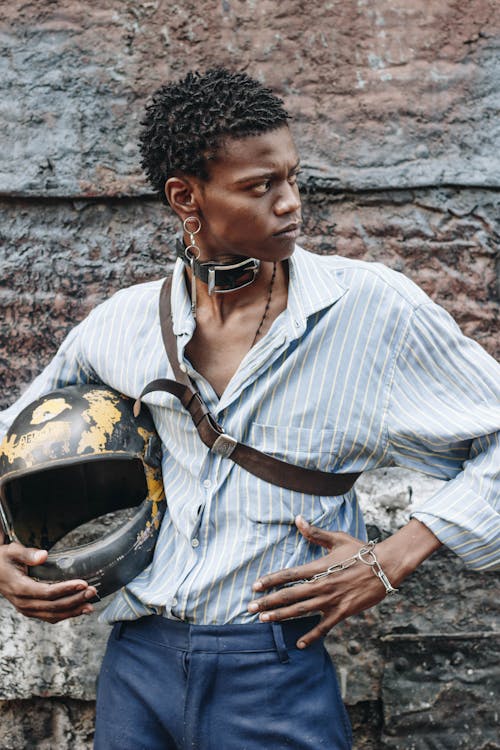 Photo Of Man Holding Helmet