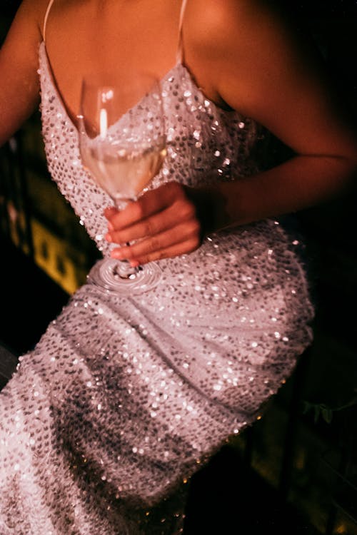 Woman In White Sequined Spaghetti Strap Dress