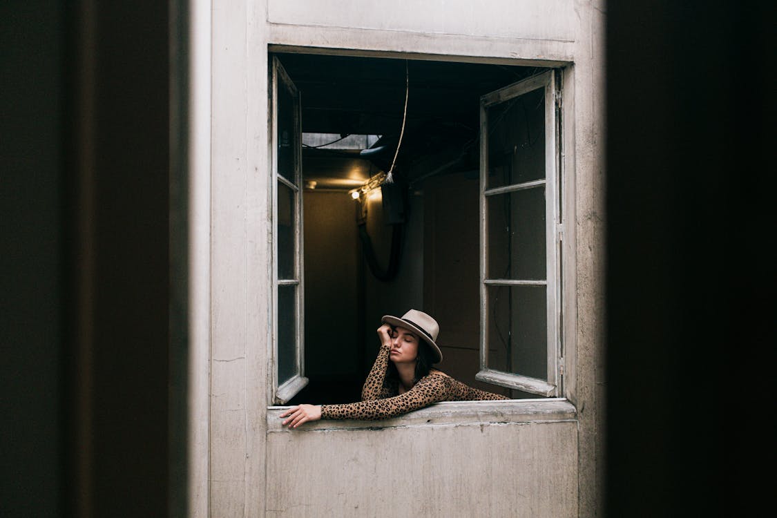 Photo Of Woman Leaning On Window