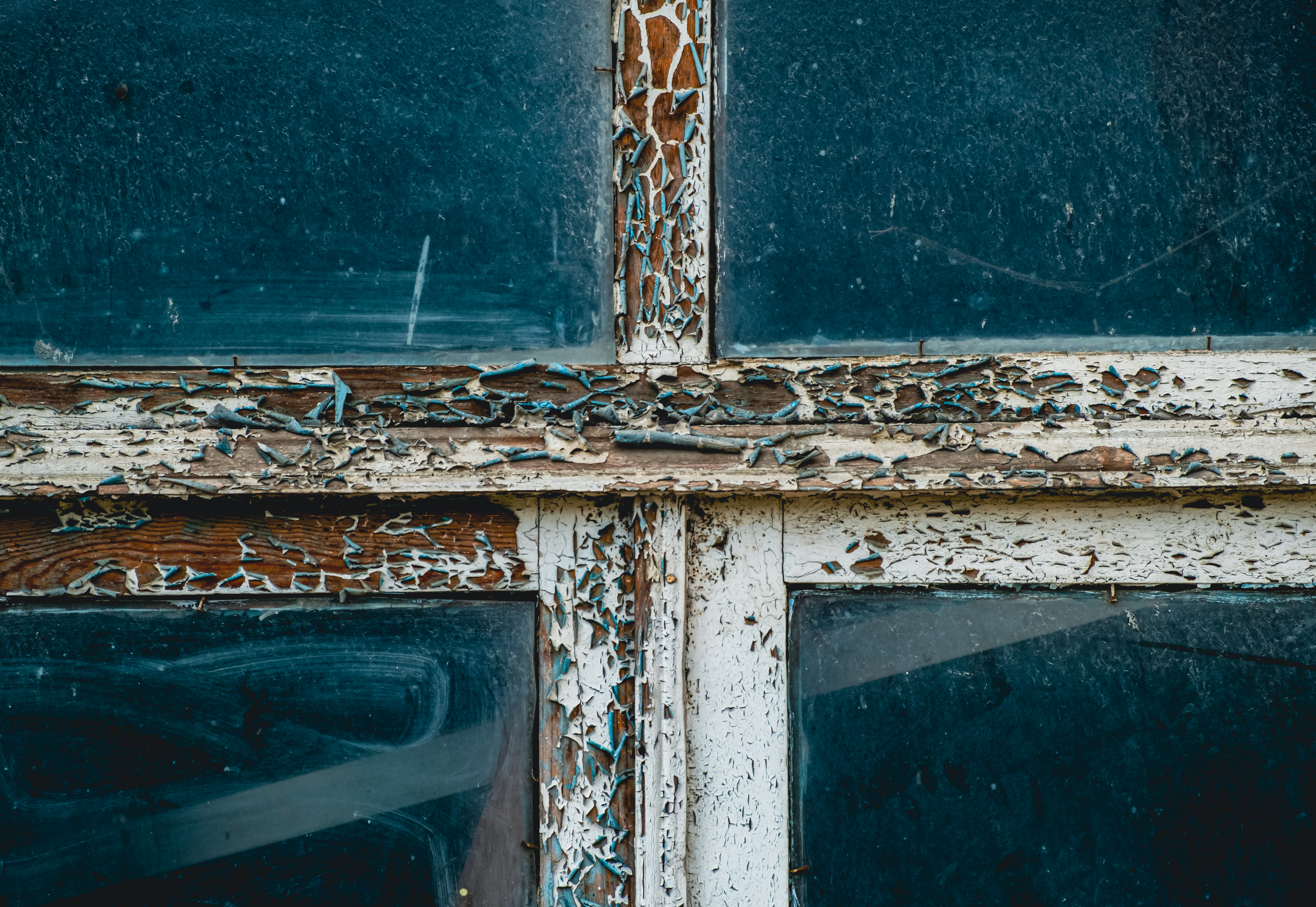Close-up of worn and cracked window weatherstripping on a wooden sash - double hung window draft stopper
