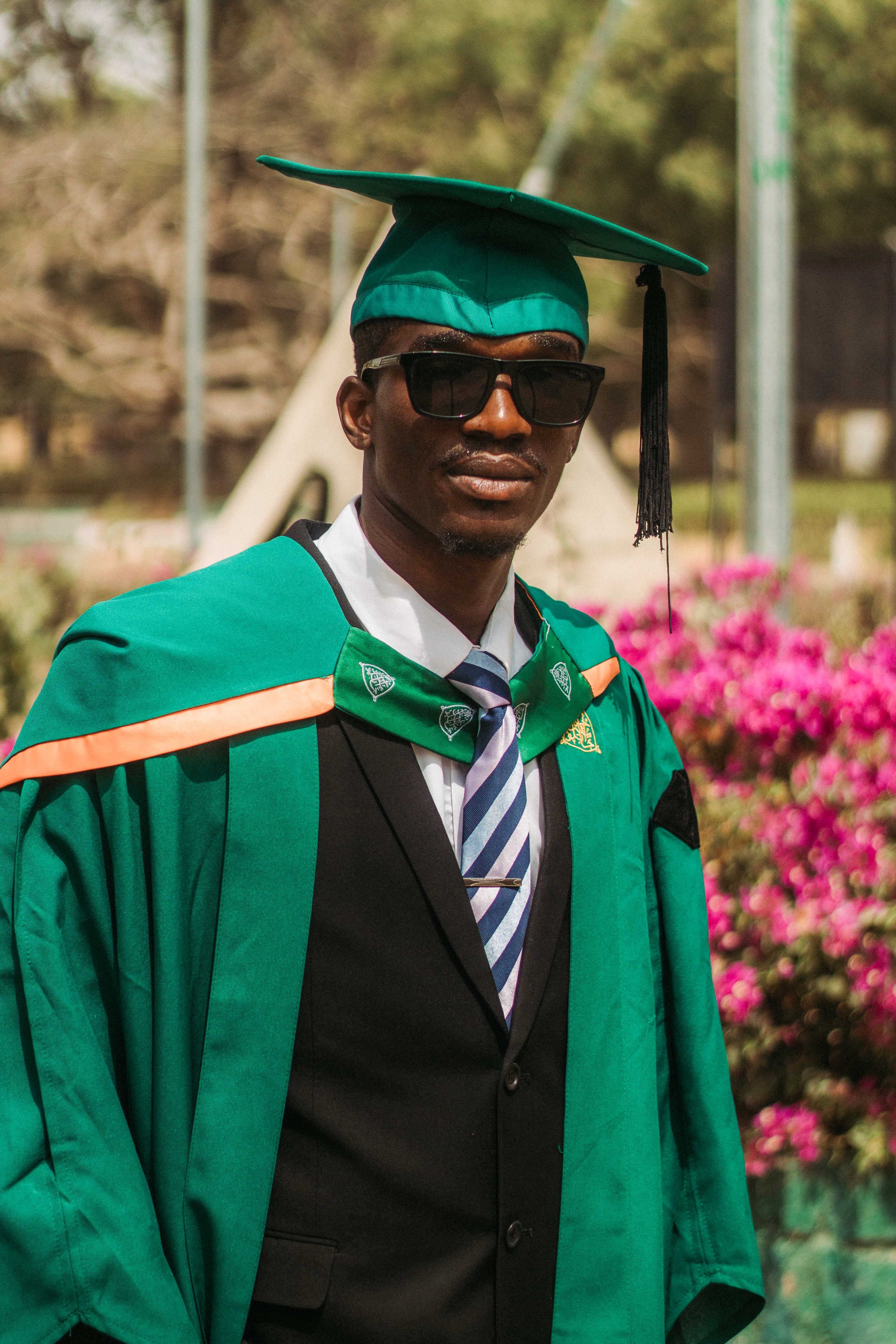 Graduation Day Celebration in Green Gown · Free Stock Photo