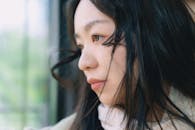 Thoughtful Young Woman by the Window
