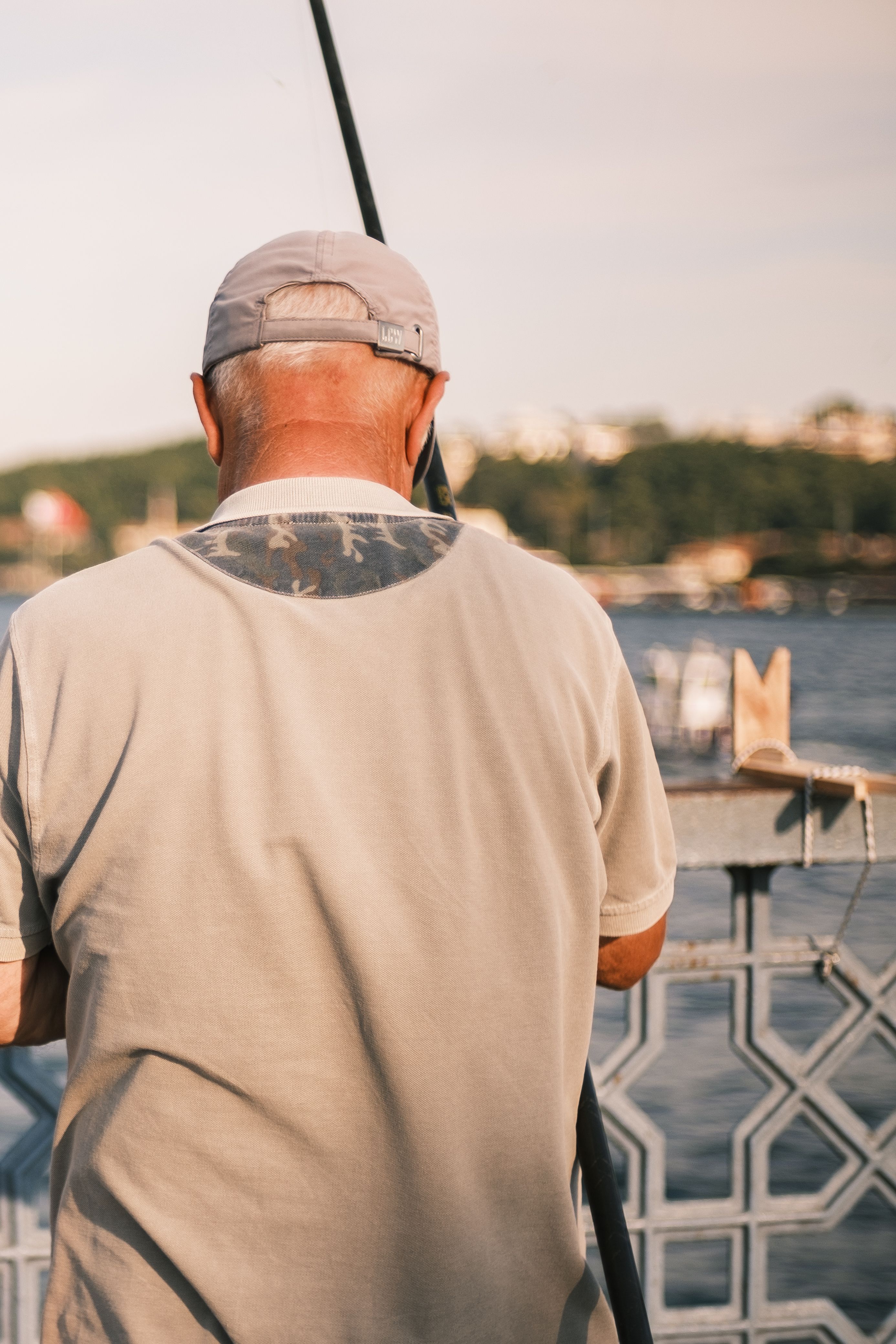 Senior Man Fishing by the Riverside · Free Stock Photo