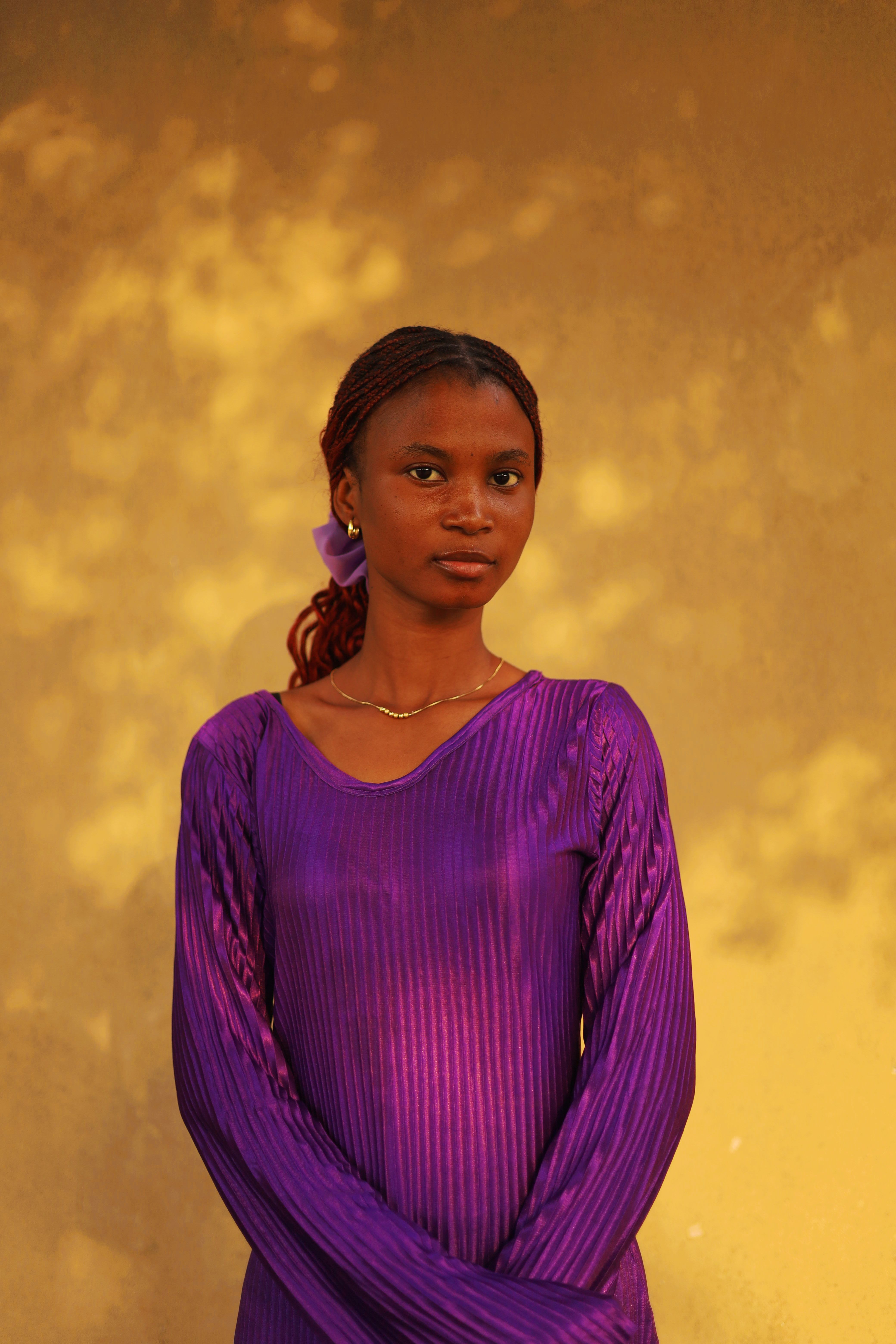 Elegant Portrait of a Woman in Purple under Golden Light · Free Stock Photo