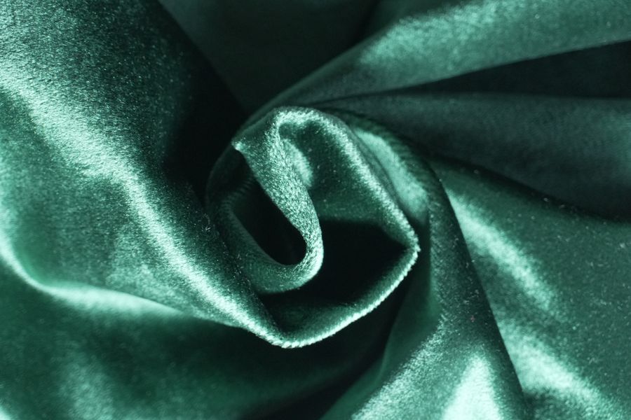 Close-up of emerald green velvet suede texture — photo by Marina Endzhirgli on Pexels