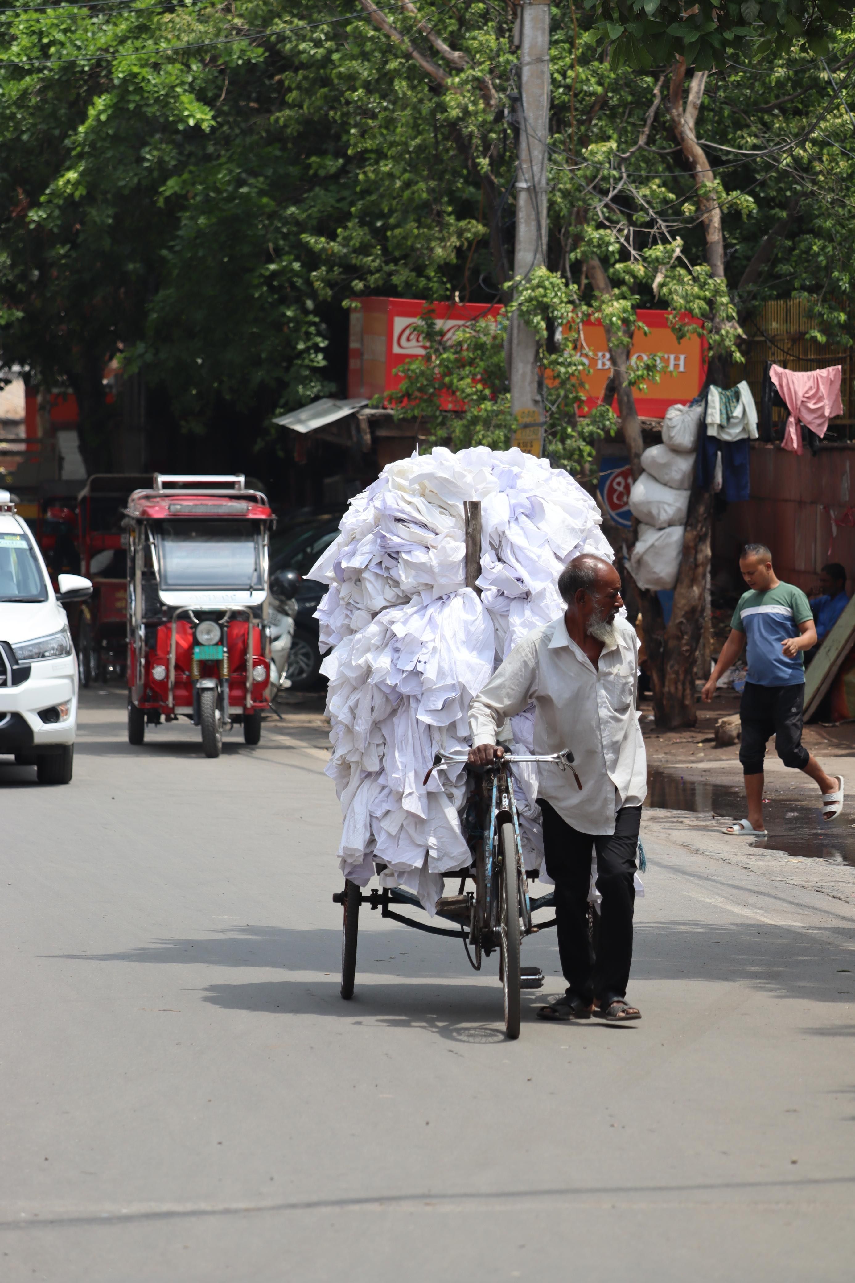 Man transporting large bundle on bicycle rickshaw · Free Stock Photo