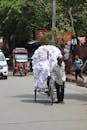 Man transporting large bundle on bicycle rickshaw