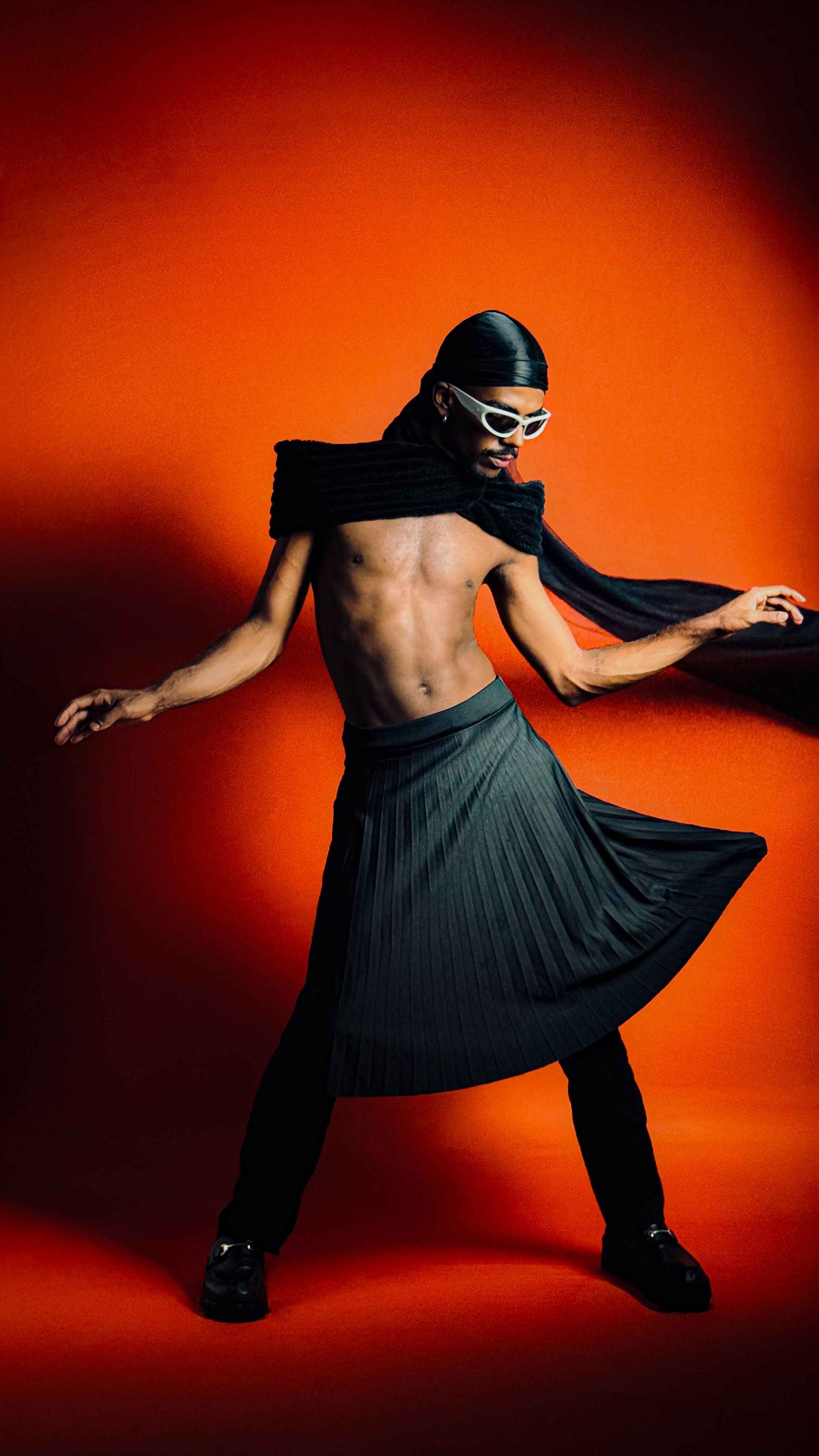Stylish Male Dancer in Dynamic Pose on Orange Background · Free Stock Photo