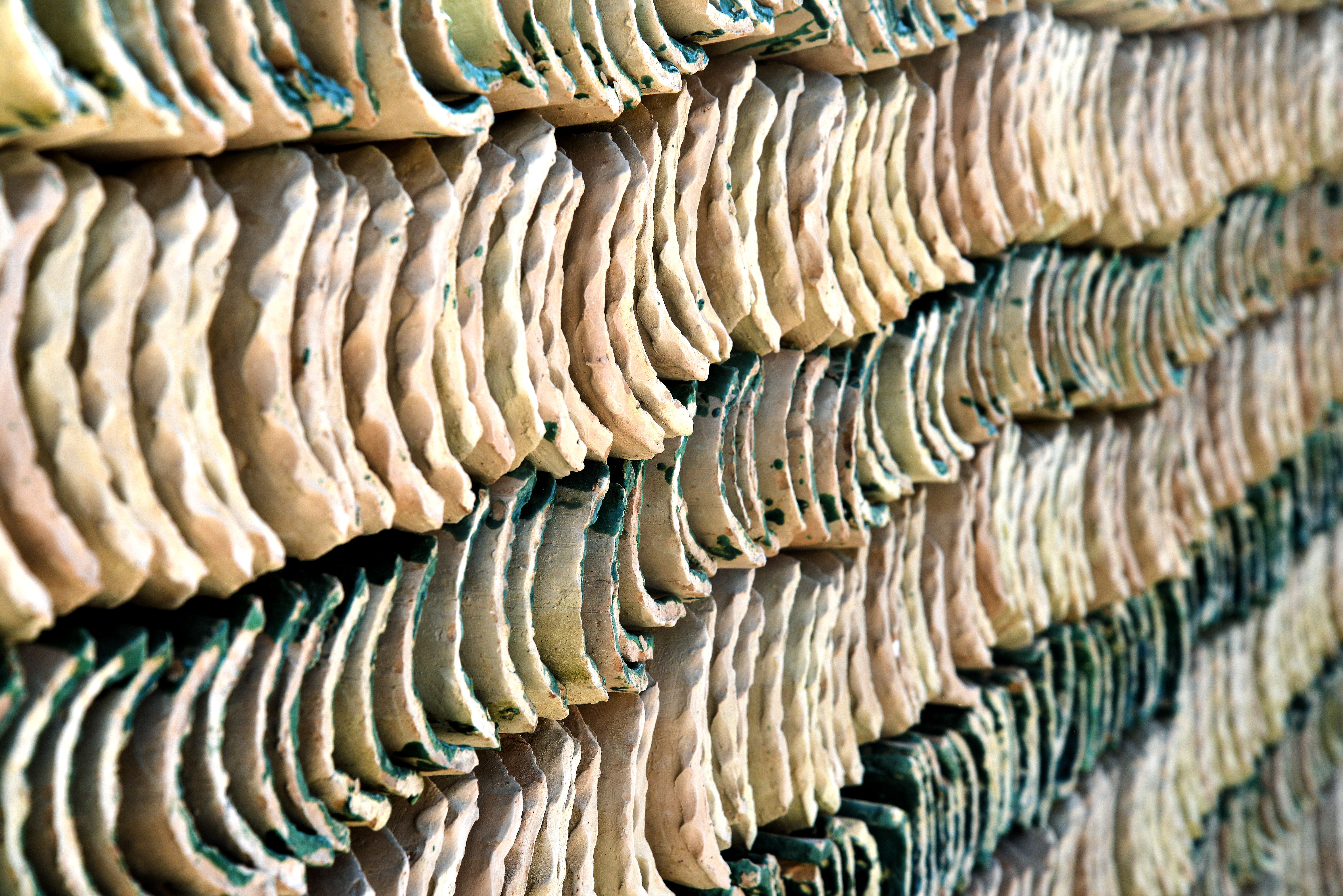 Close-up of handcrafted pottery drying in the sun in Fès, Morocco showcasing traditional craftsmanship.