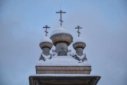 Free A snow-covered Russian Orthodox church in Arkhangelsk, showcasing traditional wooden architecture. Stock Photo
