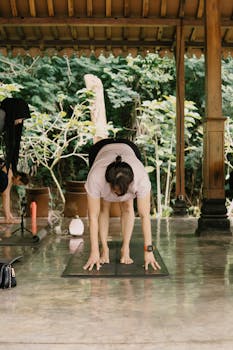 A group of adults participating in an outdoor yoga session in a serene environment in Jawa Barat, Indonesia.