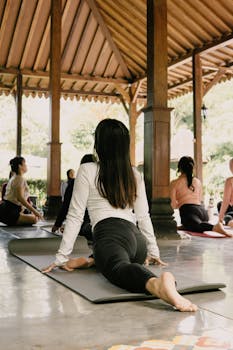 A diverse group practicing yoga in a serene outdoor pavilion in Indonesia.