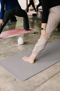 Outdoor group yoga class in Jawa Barat, Indonesia, focusing on relaxing poses on mats.
