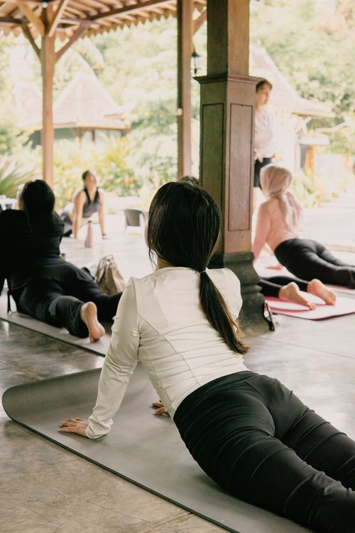 Free Adults practicing yoga poses outdoors in a serene setting, Jawa Barat. Stock Photo