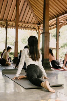 Experience outdoor group yoga at a serene pavilion in Jawa Barat, Indonesia. Perfect for relaxation and fitness.