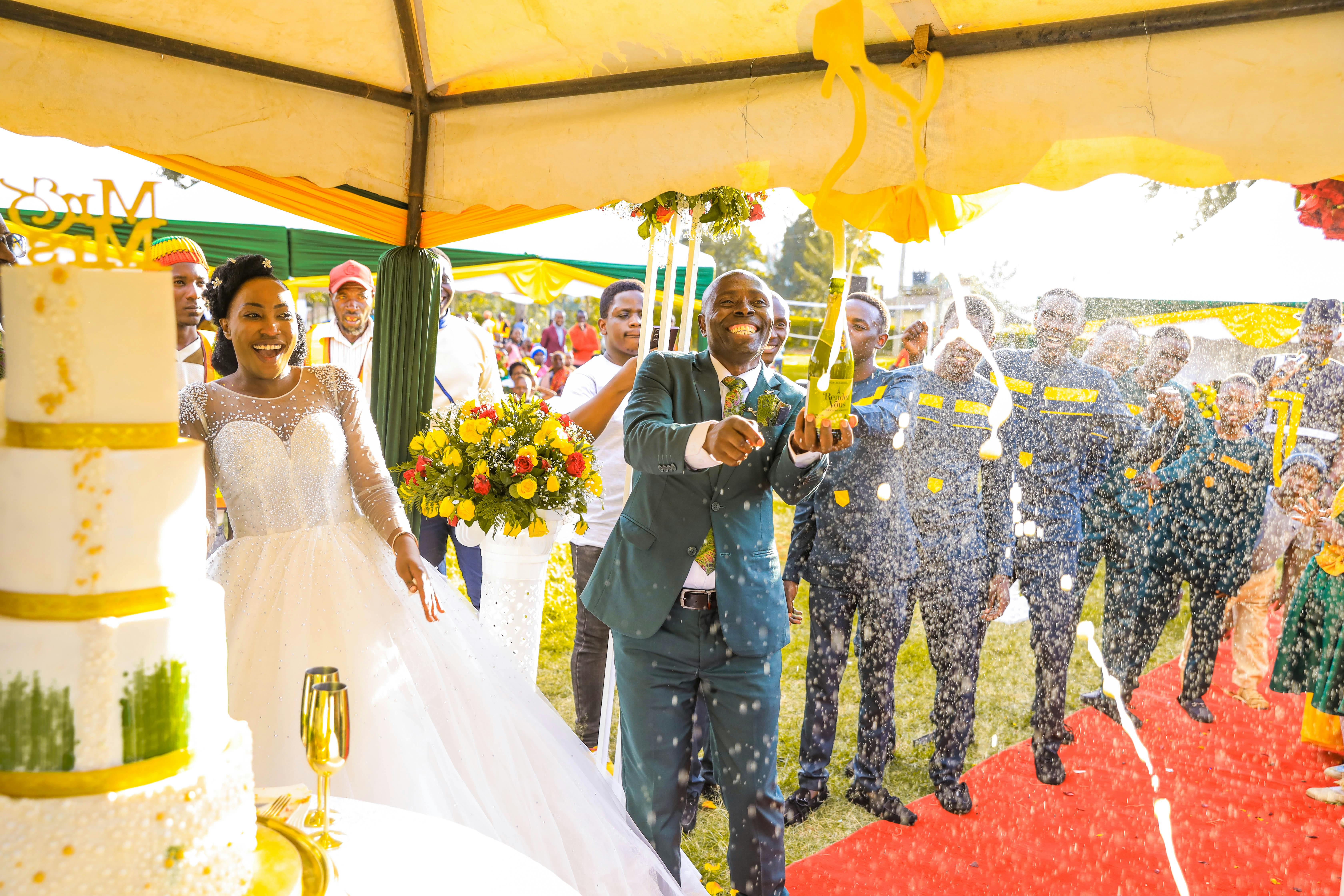 Bride and groom celebrating with a champagne toast at an outdoor wedding ceremony.