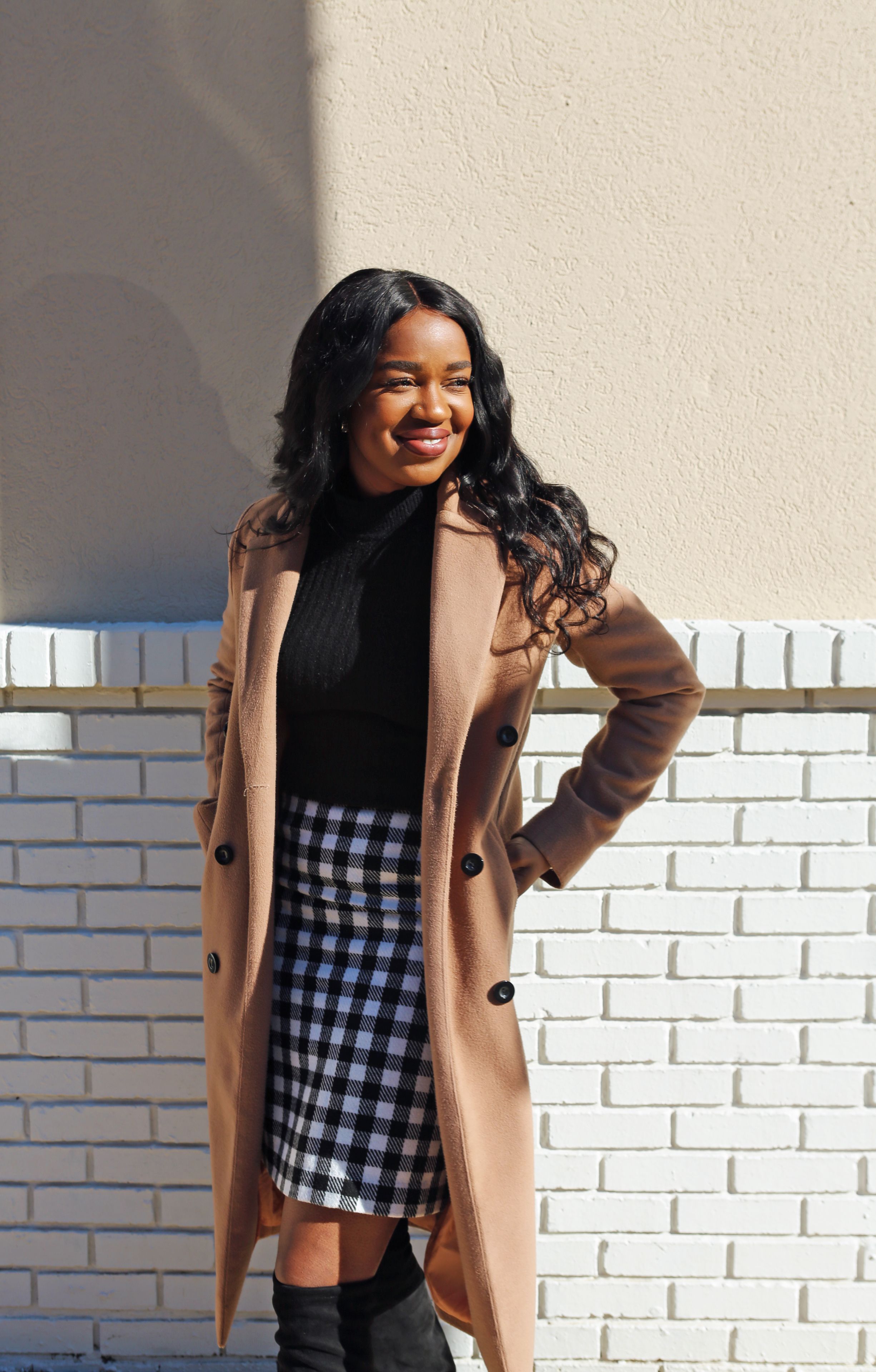 Woman in Brown Coat Standing Beside White Wall · Free Stock Photo