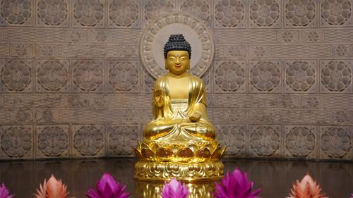Free Peaceful golden Buddha statue with lotus flowers in Seoul, South Korea. Stock Photo