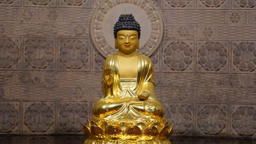Free Golden Buddha statue in a Seoul temple, reflecting Buddhist spirituality. Stock Photo
