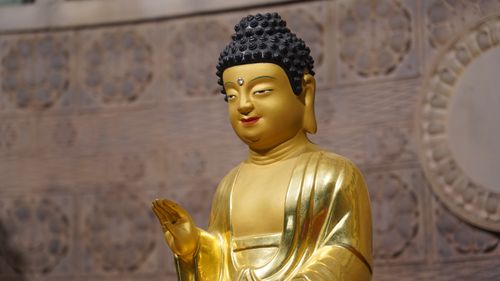 Free A detailed view of a golden Buddha statue in a Seoul temple. Stock Photo