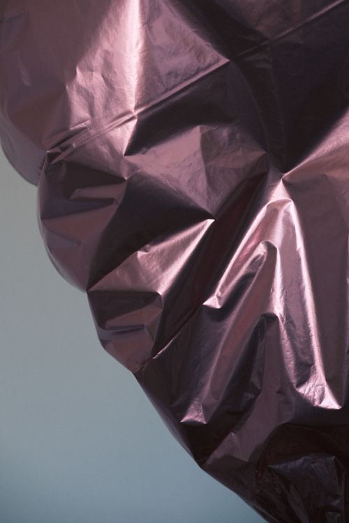 Free Close-up of crumpled shiny metallic foil with a subtle purple tint, creating an abstract texture. Stock Photo
