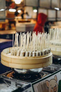 Close-up of skewered food at a vibrant Bangkok night market, capturing the essence of Thai street cuisine.