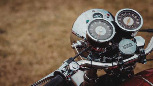 Free A detailed view of a vintage motorcycle's dashboard featuring classic gauges and chrome details. Stock Photo