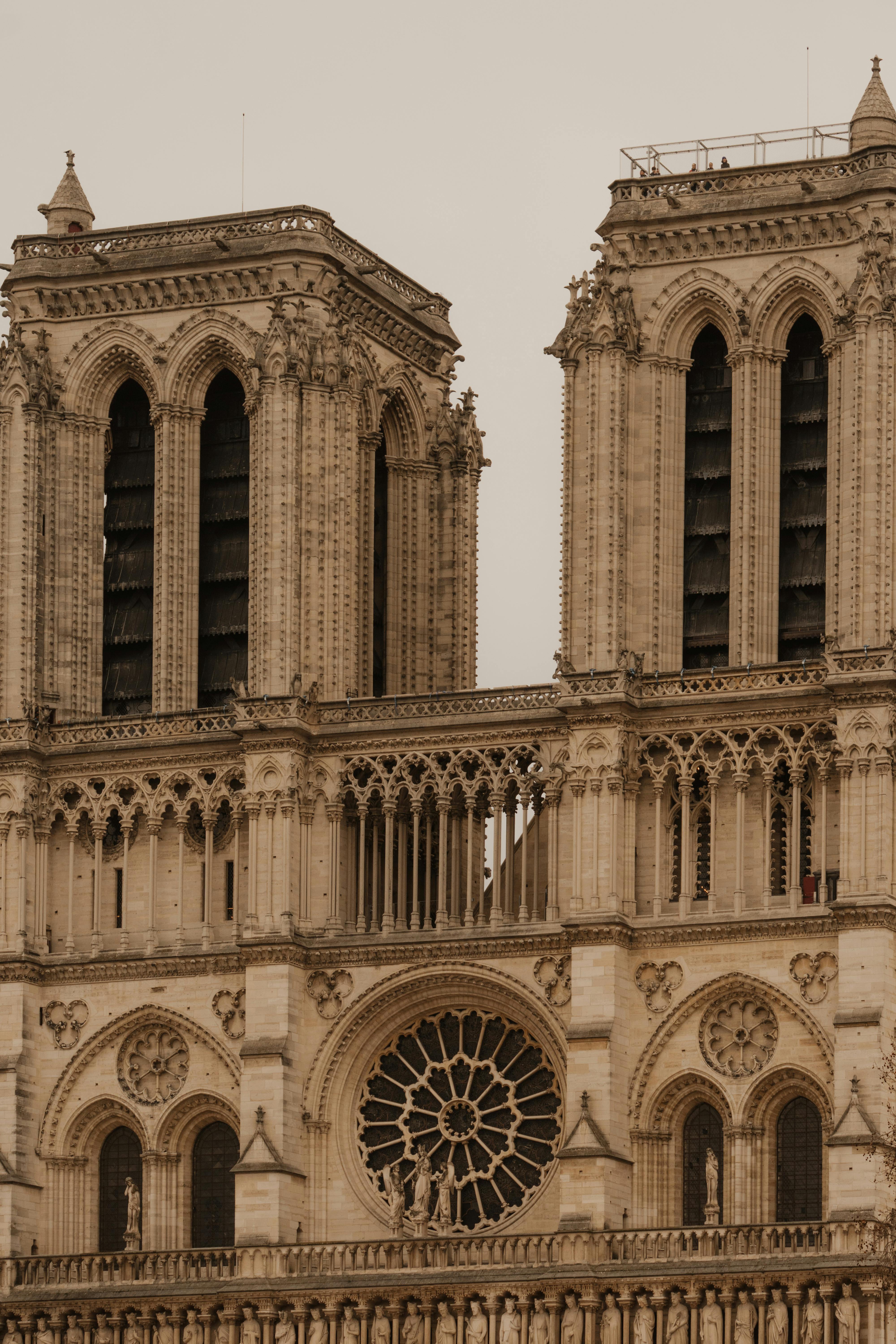 Notre-Dame Cathedral in Paris showcasing its stunning Gothic architecture with detailed stone carvings, flying buttresses, rose windows, and iconic twin towers on the Île de la Cité