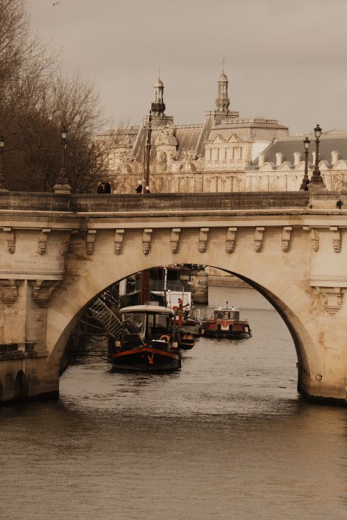 Free Discover the timeless beauty of Paris with this view of the Pont Neuf over the Seine River, capturing the essence of French architecture and culture. Stock Photo