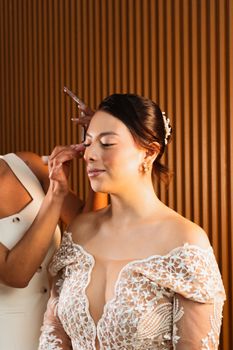 Close-up of a bride getting her makeup done. Perfect for wedding themes.