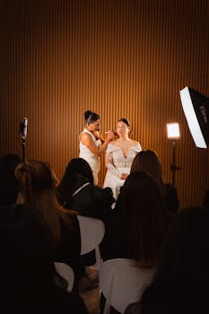 Makeup artist perfecting bride's look during a wedding demonstration in Mexico City.