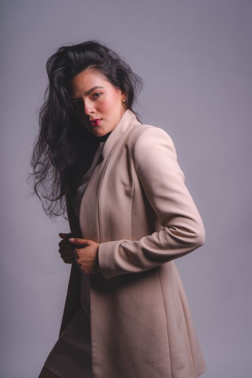 Free Stylish portrait of a woman in a beige blazer from Mexico City, showcasing modern fashion trends. Stock Photo