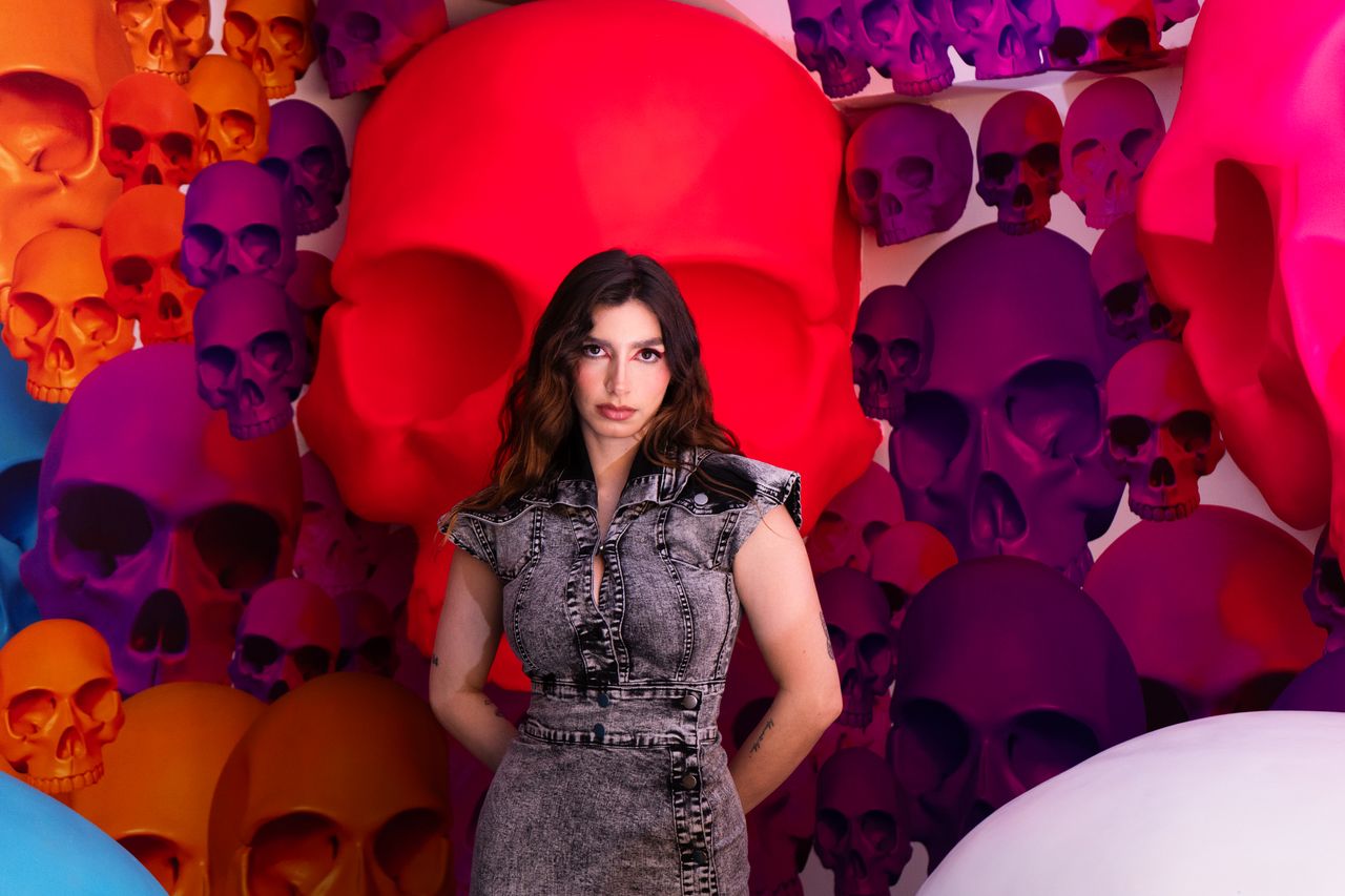 a striking portrait of a woman in a colorful skull art installation