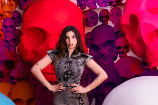 Model posing inside an artistic skull installation in Mexico City, showcasing vibrant colors and creativity.