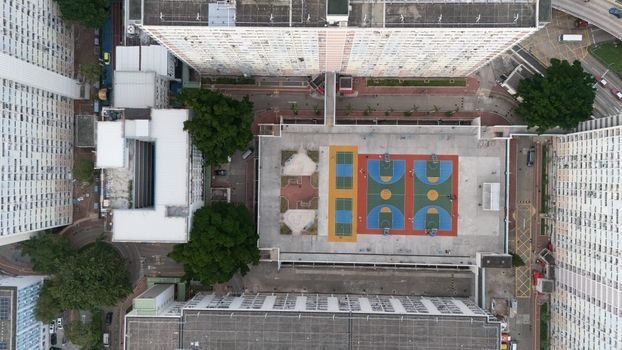 Aerial shot of colorful basketball courts in urban Kowloon, Hong Kong.