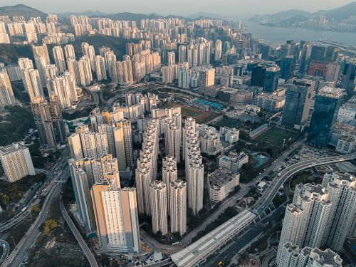 Free Explore the dense urban skyline of Kowloon, Hong Kong with towering skyscrapers and intricate roadways. Stock Photo
