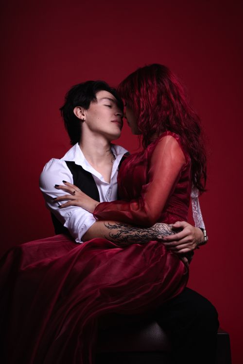 Free Passionate couple in love sharing an intimate moment in a red, romantic ambiance. Stock Photo