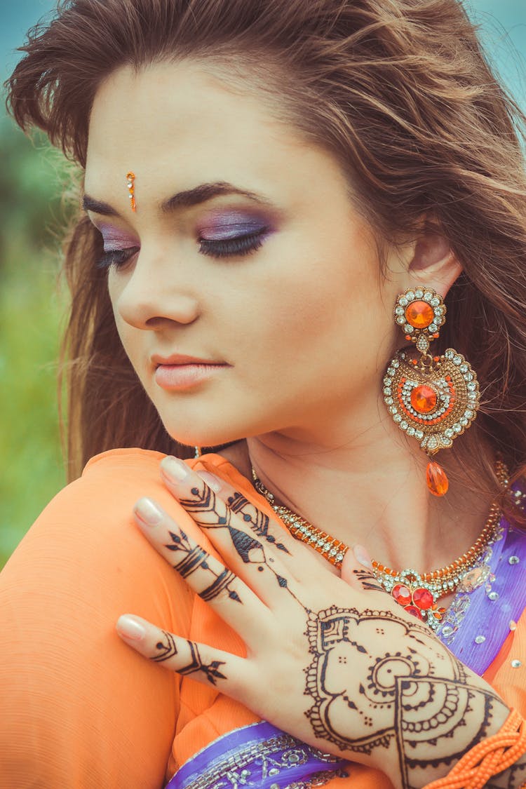 Close Up Photo Of Woman With Henna Tattoo On Her Hand