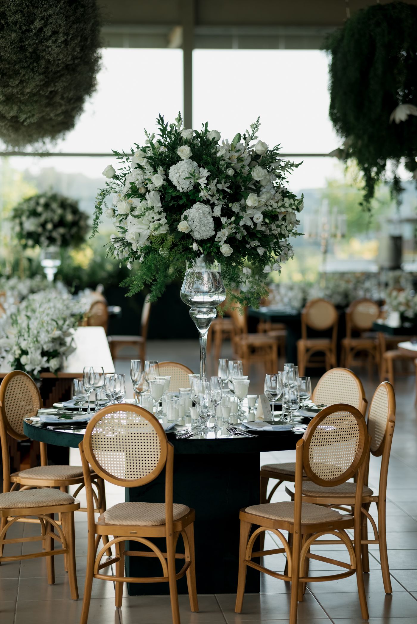 Luxury wedding reception with tall floral centerpieces