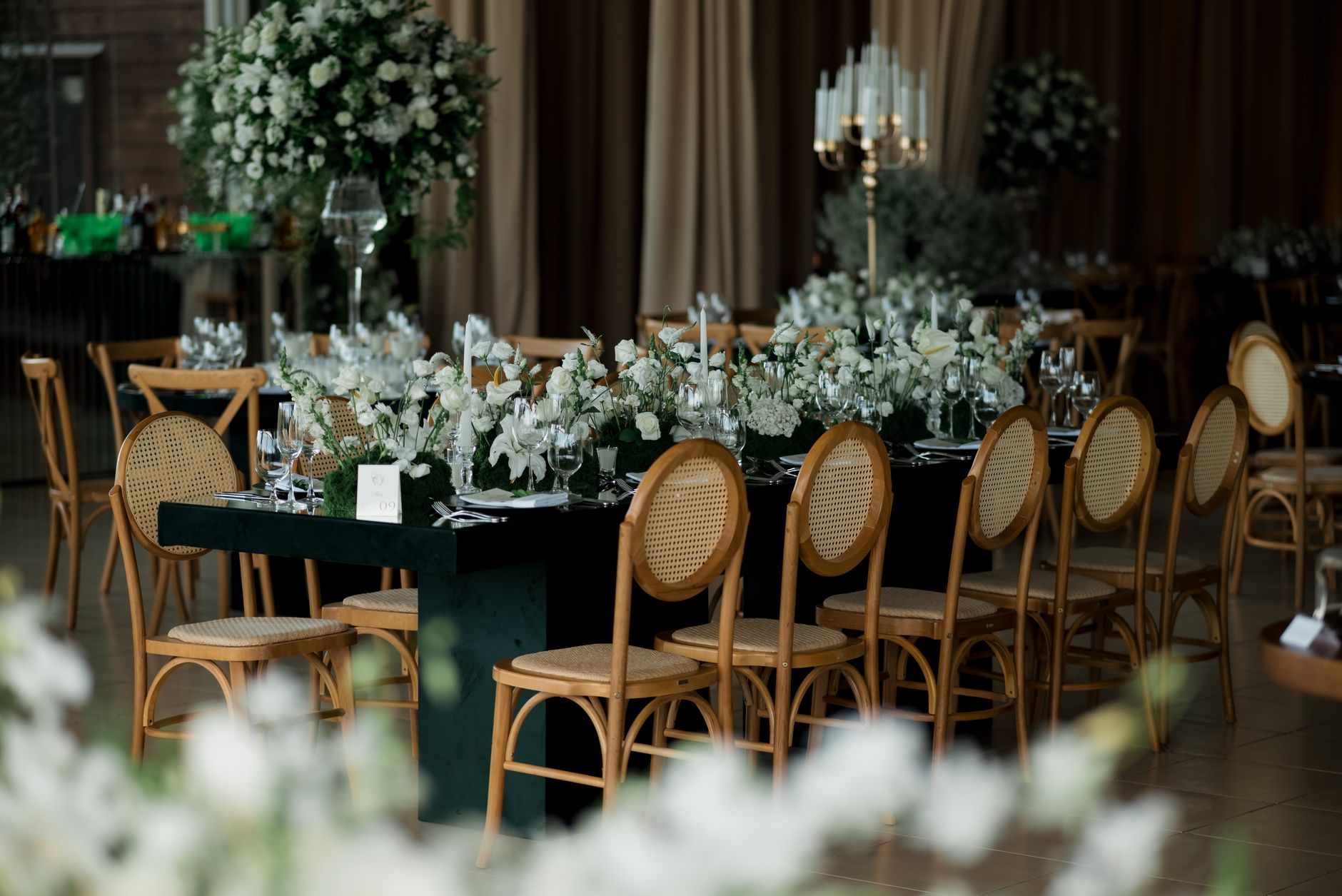 Beautifully arranged wedding table with floral decorations and elegant chairs, perfect for a special occasion.