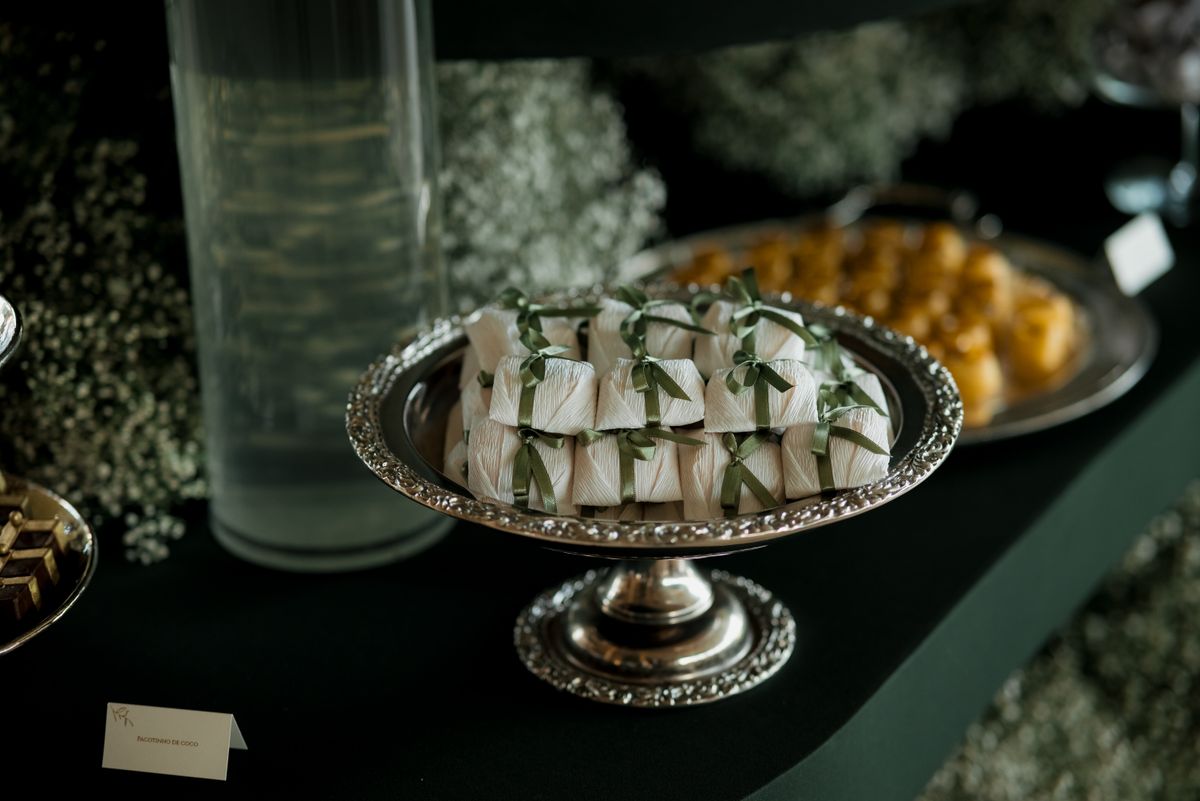 Silver tray with elegantly wrapped sweets at a sophisticated event, showcasing gourmet presentation.