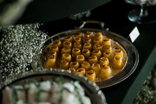 Free A silver tray showcasing vibrant yellow Turkish baklava with delicate floral decor. Stock Photo