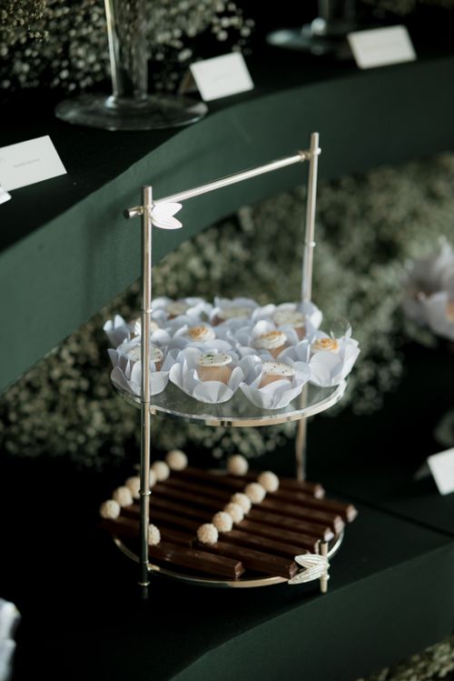 Free Chic and sophisticated dessert stand with floral-themed treats and chocolates. Perfect for events. Stock Photo
