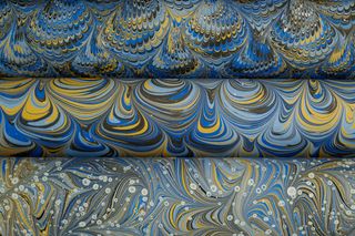 Stacked marbled sheets in blue and yellow — photo by betül nur akyürek on Pexels