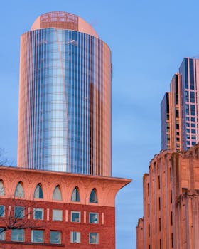 Skyline view of modern skyscrapers in Boston, Massachusetts, showcasing urban architecture under a clear blue sky.