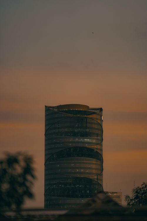 Free Gama Tower in Jakarta against a vibrant evening sky, capturing urban elegance. Stock Photo